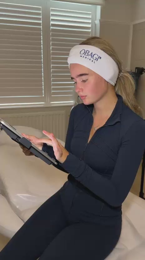 Client filling in her consultation form on a tablet