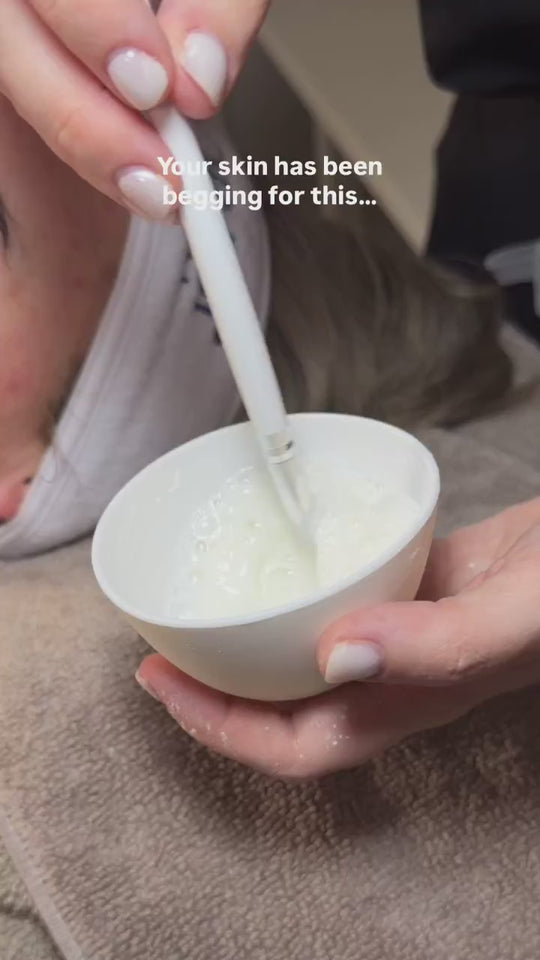 Facial mask being applied with a brush